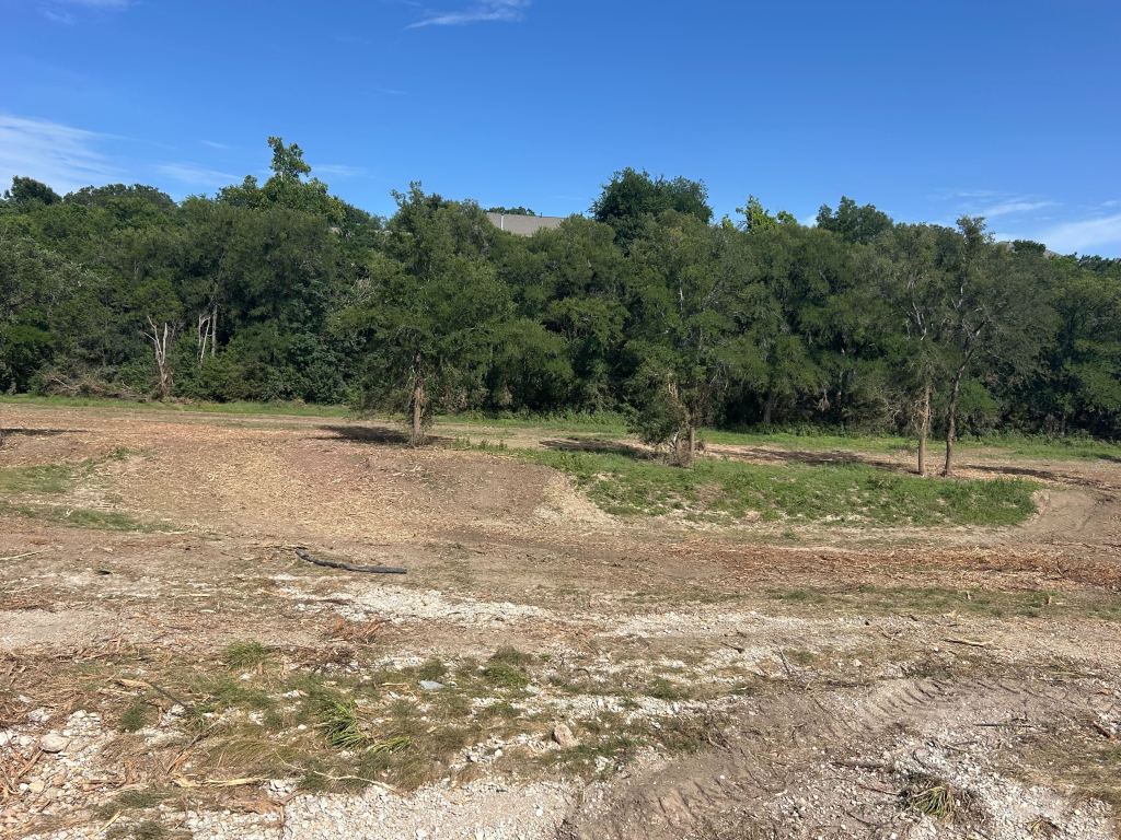 Creek bottom pasture cleaned up after land clearing near Round Rock TX