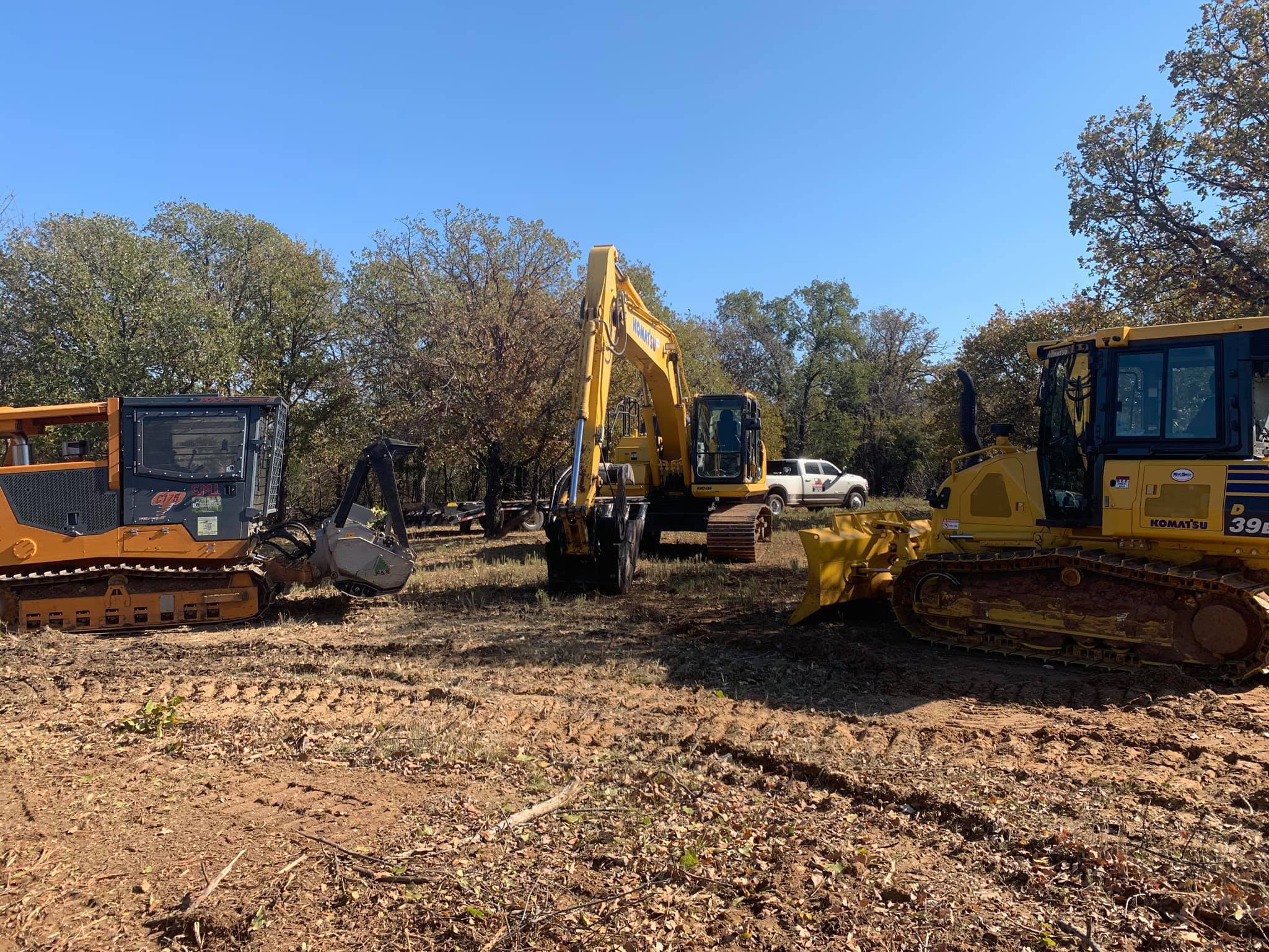 Dozer and excavators staged on a Central Texas dirt work job