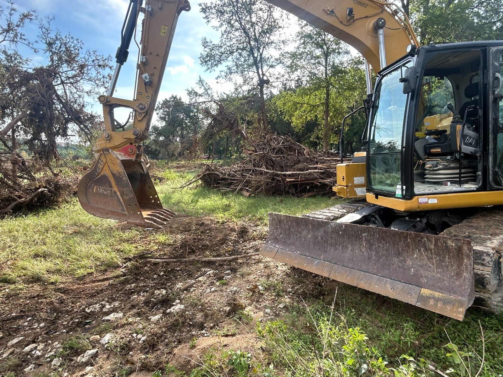 Excavator clearing storm debris in Williamson County TX