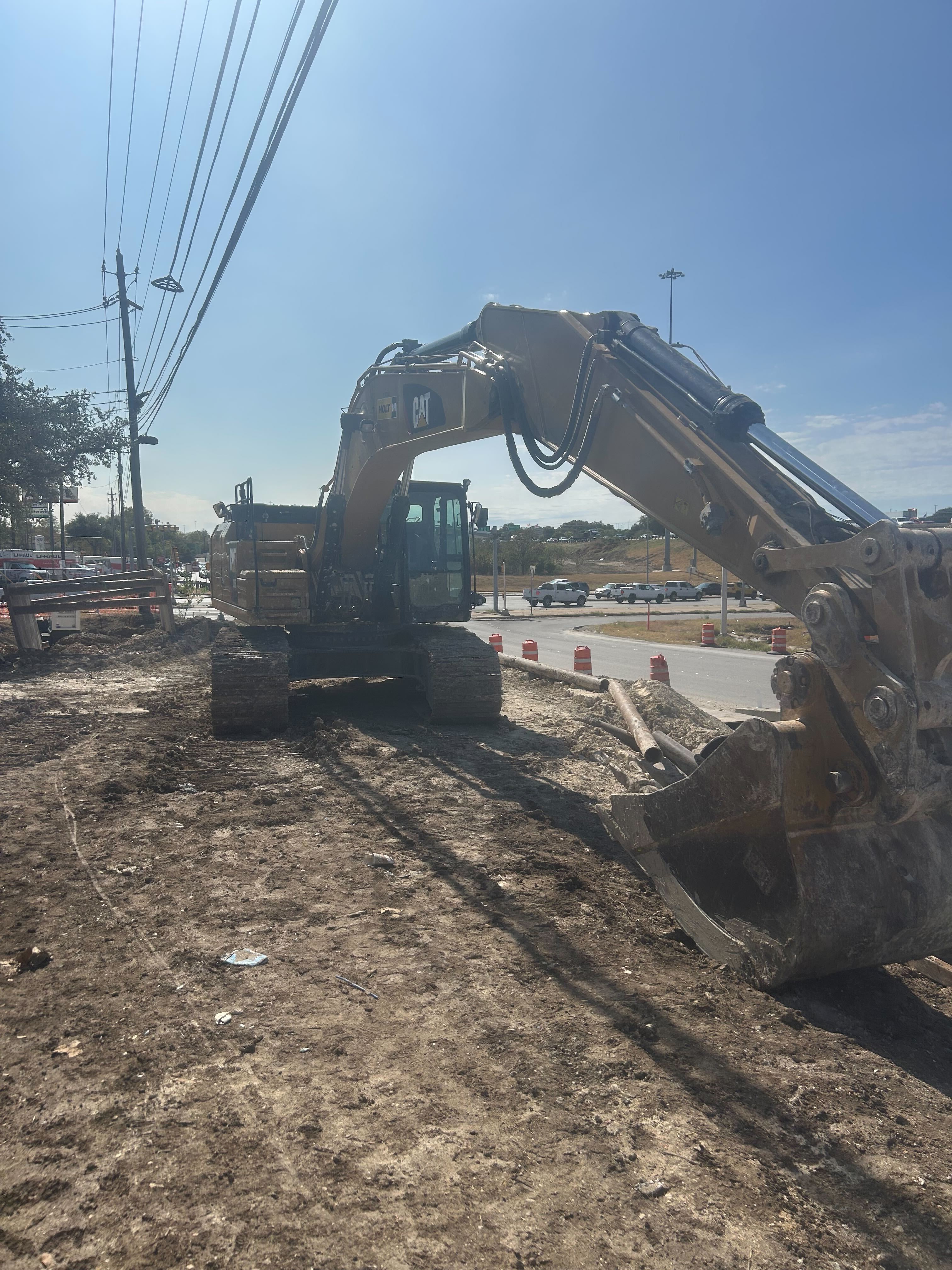 Excavator working a roadside clearing job in the Austin area