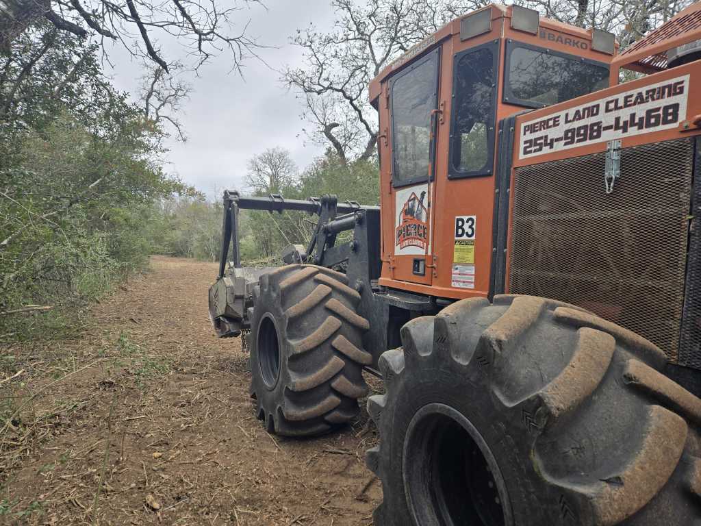Forestry mulcher cutting trails through brush near Briggs TX