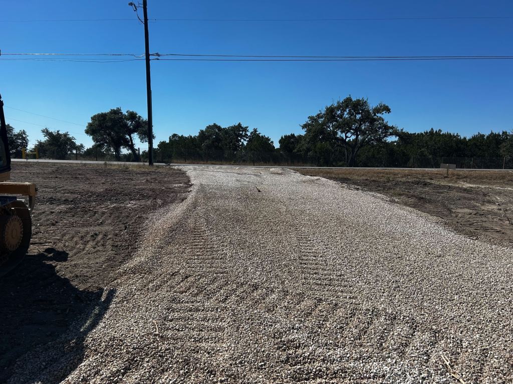 Cleared and graded site with placed stone in southeast Austin near Del Valle