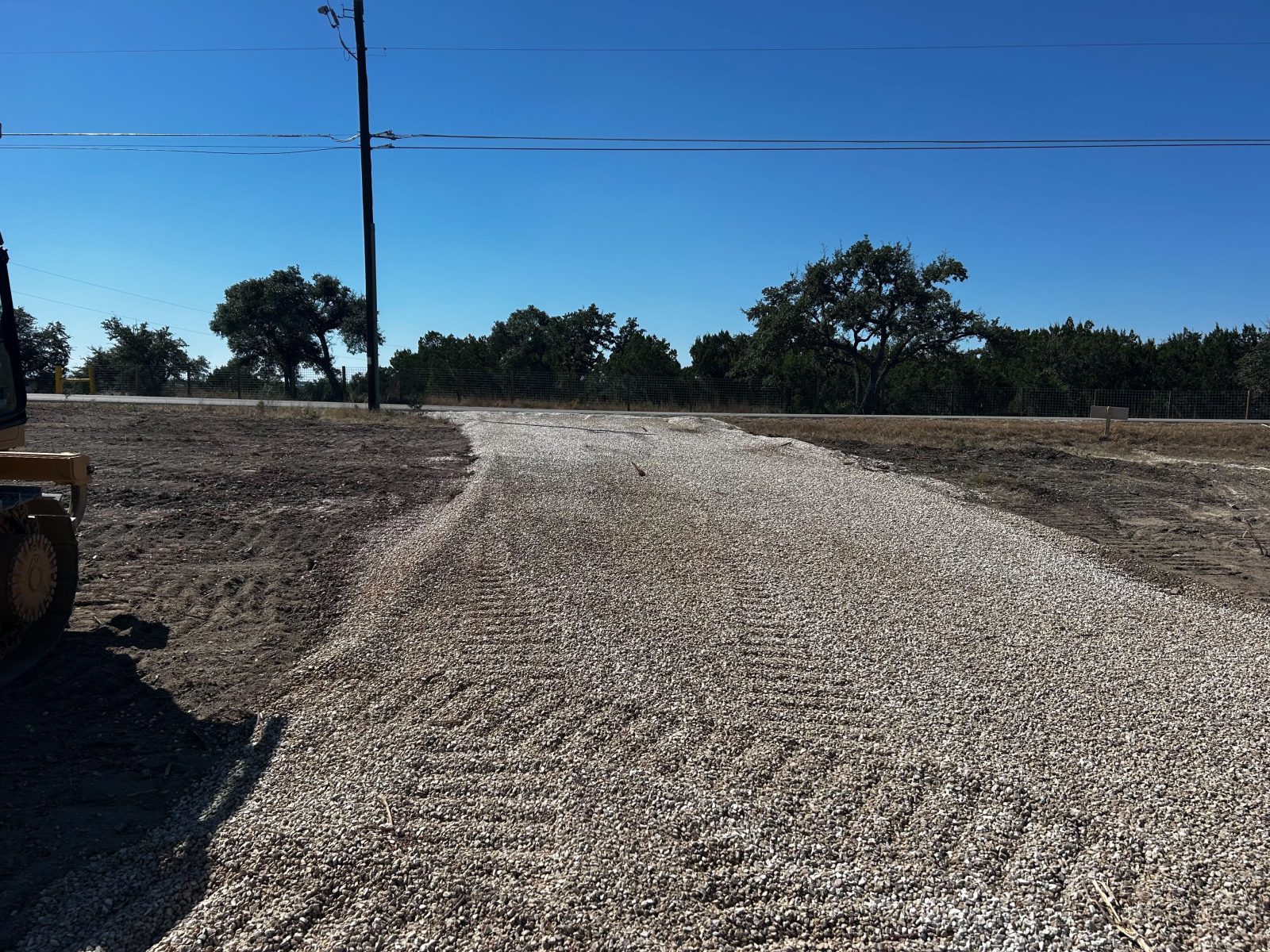 Cleared and graded site with placed stone in southeast Austin near Del Valle