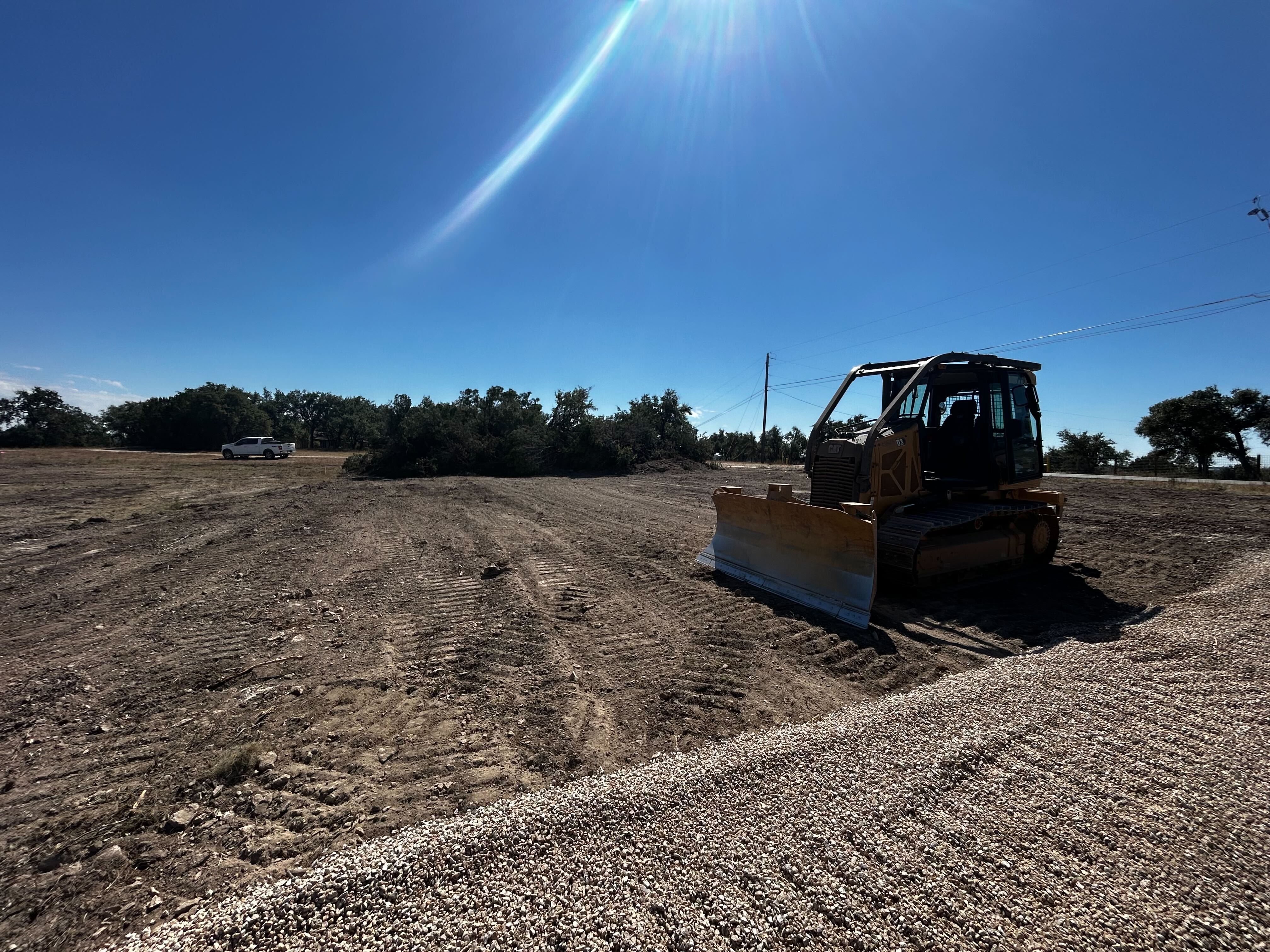 Grading and spreading gravel for a new ranch driveway near Austin TX