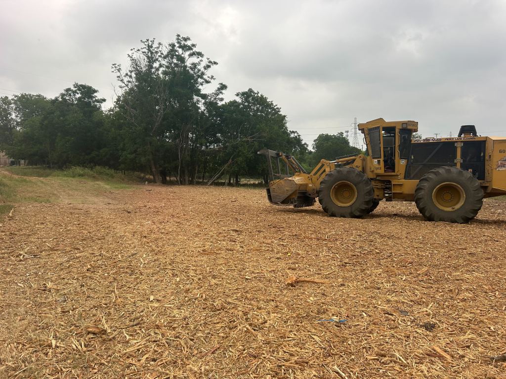 Machines working a large grounds cleanup project