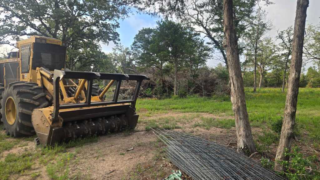 Mulching head grinding brush piles near Columbus TX