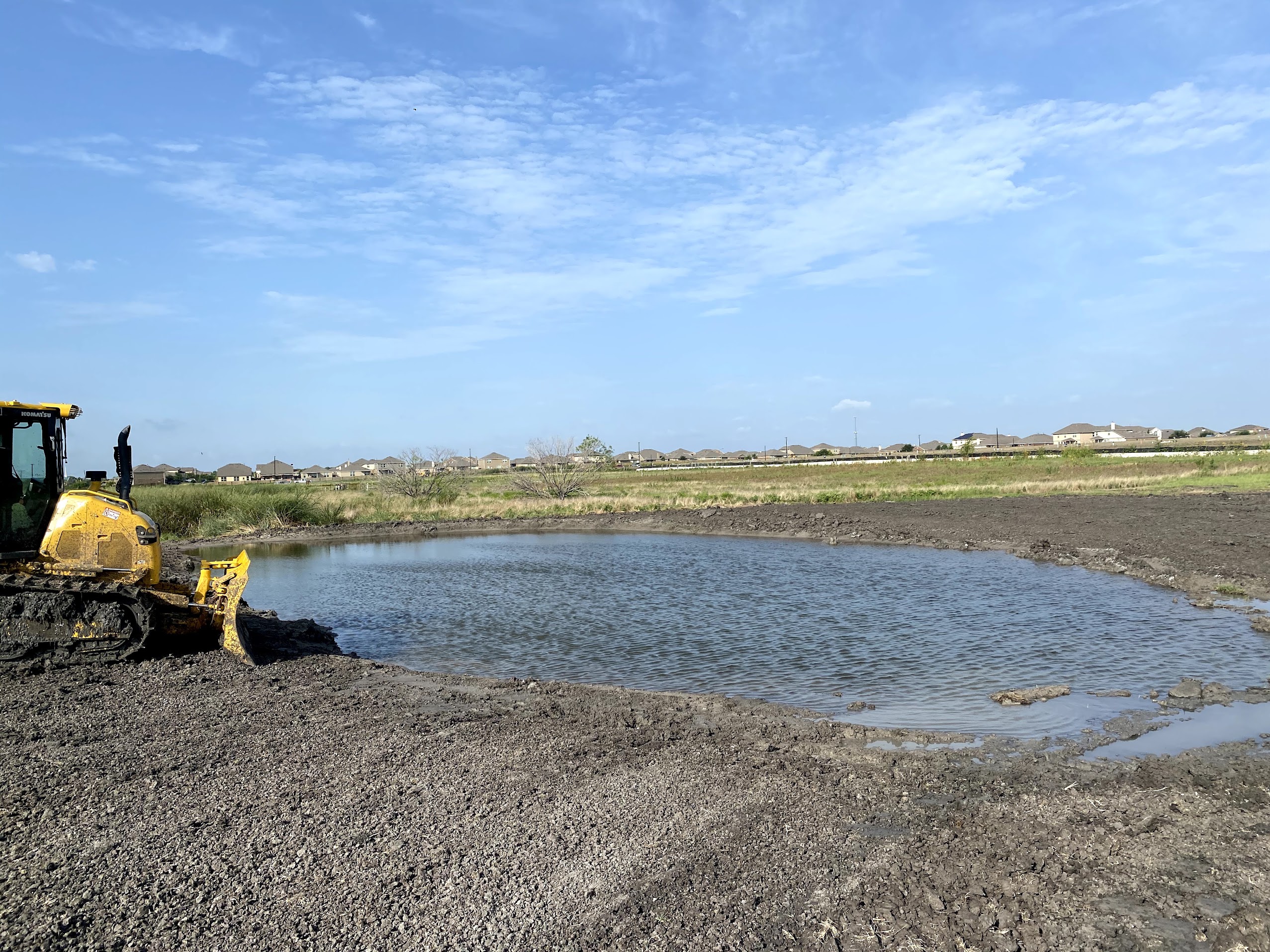Excavator digging a pond near Pflugerville Texas