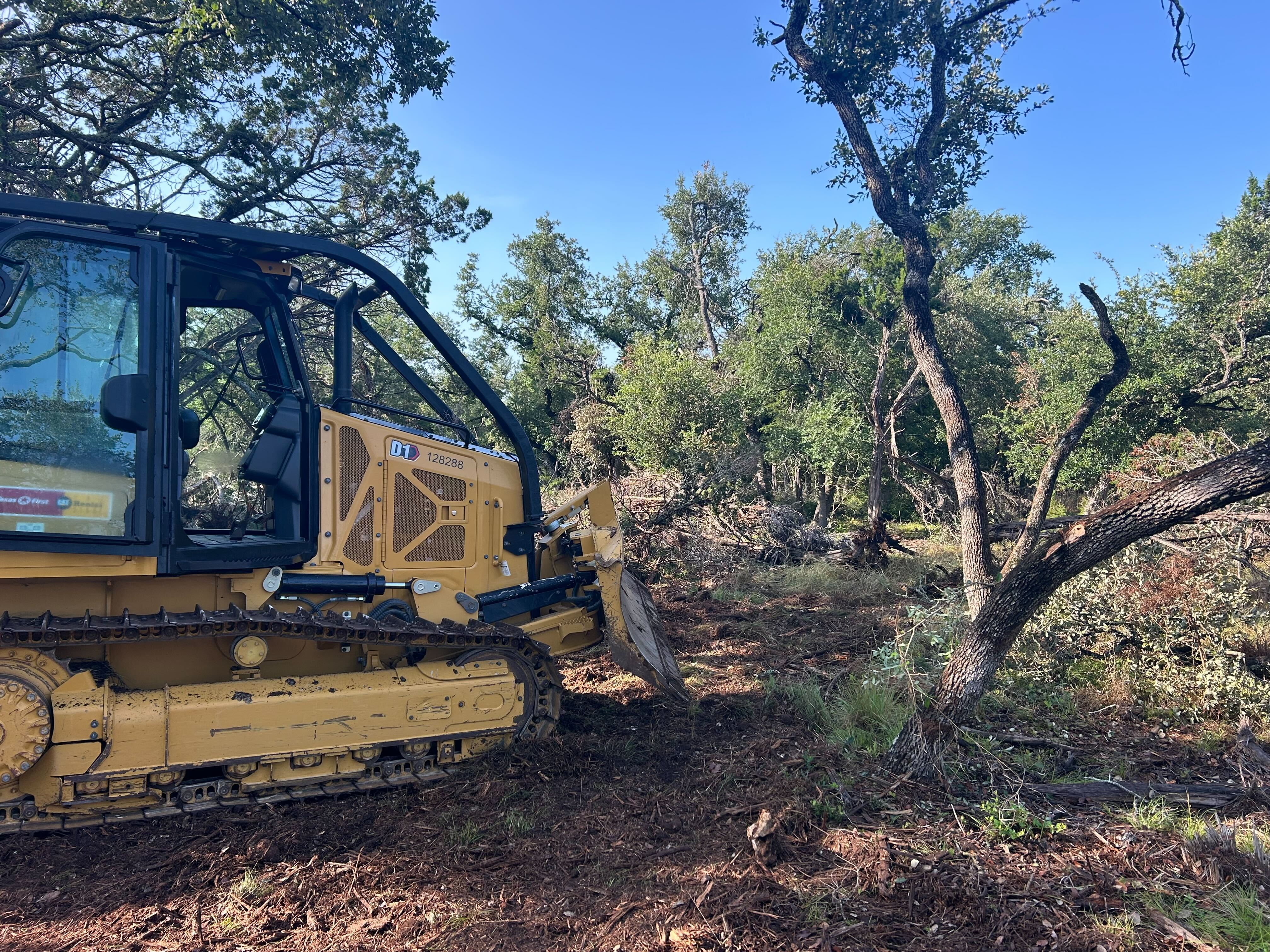 Cat D1 dozer clearing and grading a homesite pad in San Marcos Texas