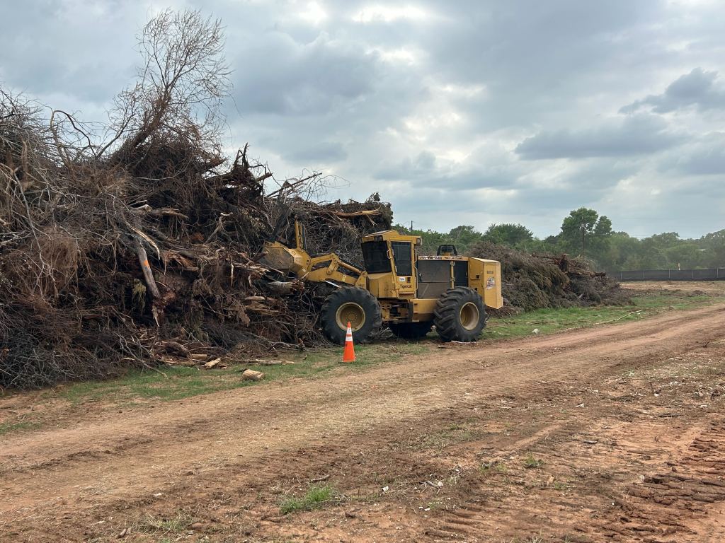 Stacked brush piles before grinding near Valley Mills TX